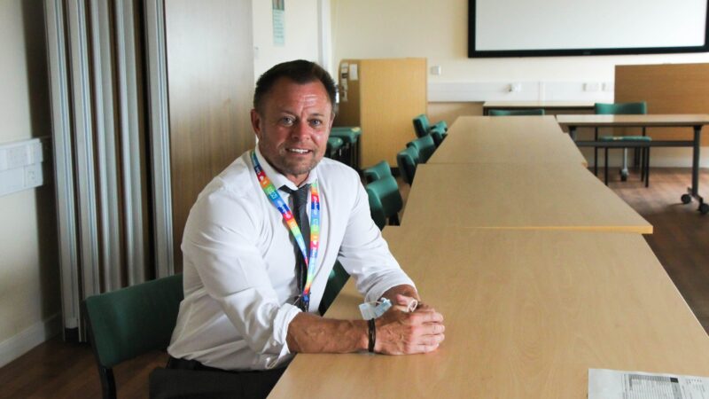 Kris Bell sitting at a desk.