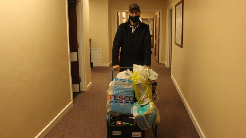 Volunteer-kenny-with-some-donated-goodies-scaled