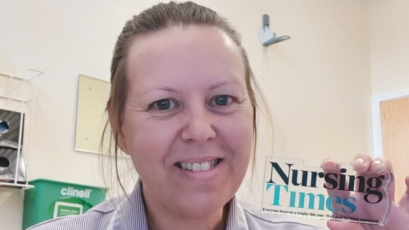 Lisa Tomlinson holds a Nursing Times award. It reads: "Nursing Times: Everyone deserves a trophy this year. Well done for being shortlisted!"