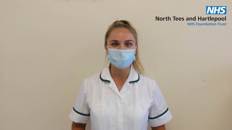 A member of staff wears a face mask.