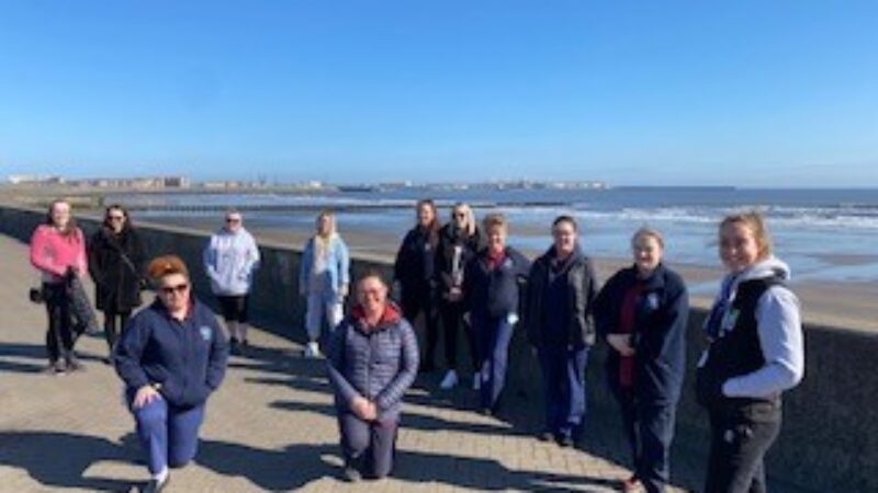 A group of women on the seafront.