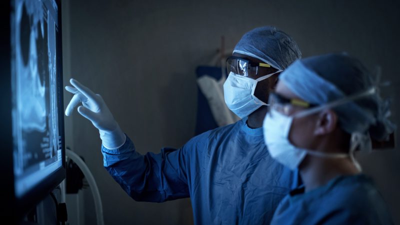 NHS Implant Analysis Service - medics reviewing xray
