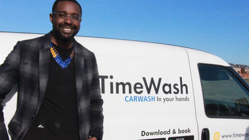 Oji Obiora stands in front of a van. The van reads: "TimeWash: Car Wash in your hands".