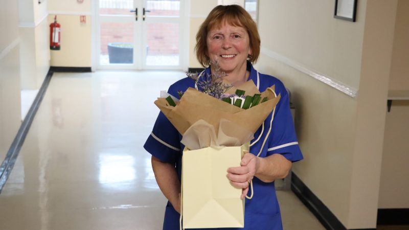 Community midwife Sheenagh Robson with flowers.