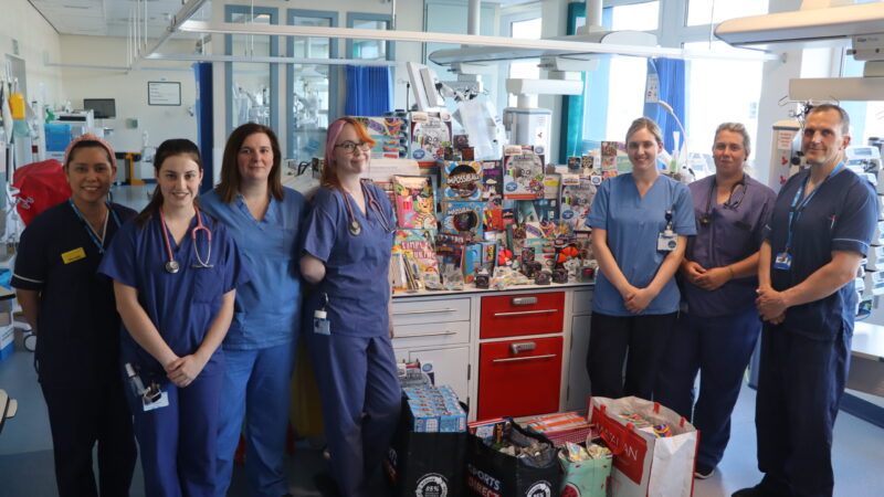 Critical care team stand alongside some of the toys donated to the unit