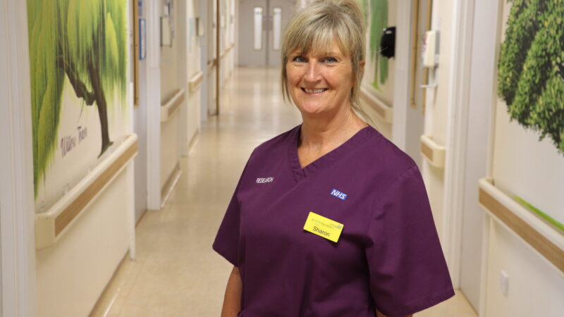 Research midwife stood in delivery suite corridor.