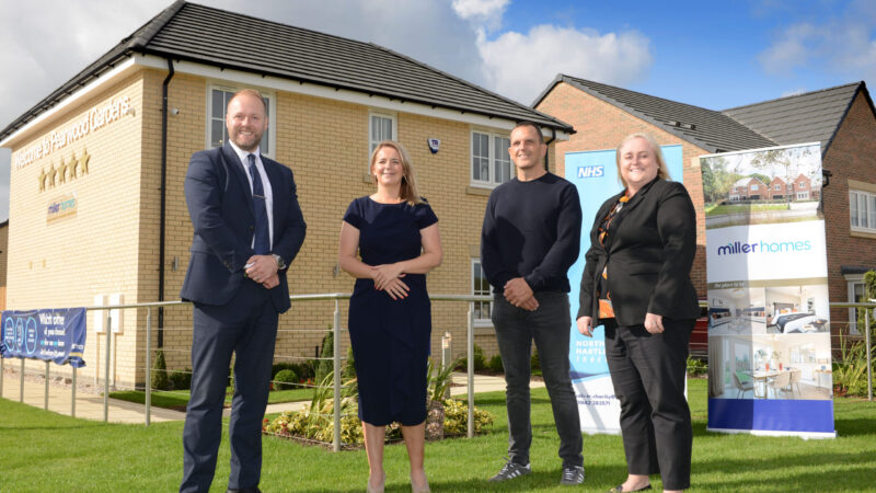 Mark Bayliss and Donna Clark from Miller Homes Teesside and Suzi Campbell and Tom Bingham from North Tees and Hartlepool NHS Foundation Trust stand outside a home.