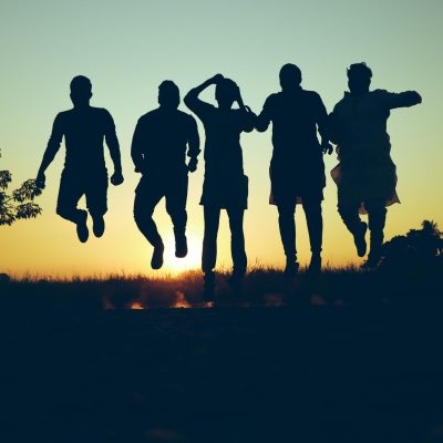 Silhouette of a group of people jumping