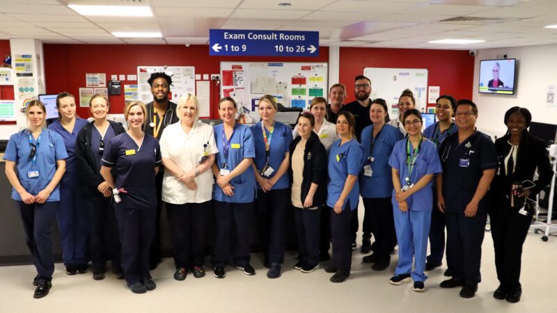 Emergency care team standing together to highlight performance target.