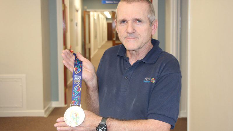 Porter David Francis with his son's International Judo Federation World Masters silver medal.