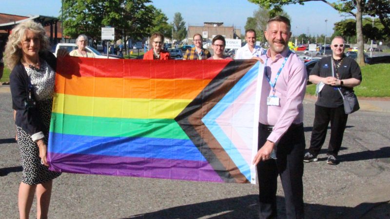 Trust staff with the LGBTQ+ flag