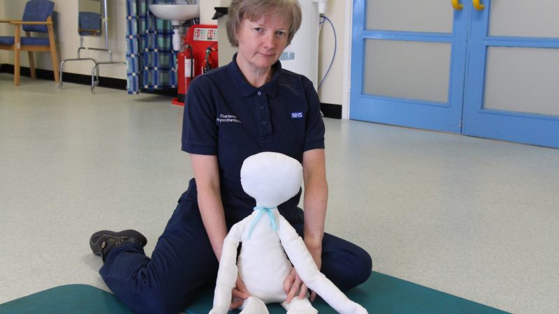 Karen Roach and the doll she uses during a video consultation