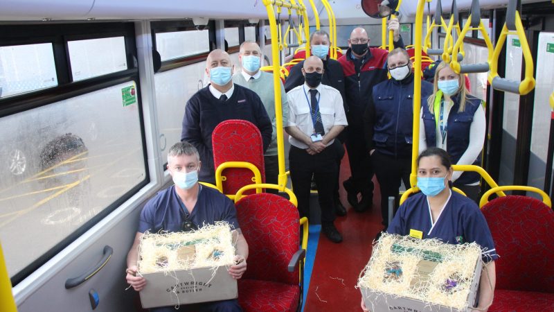 Teesside Stagecoach staff and critical care staff on a bus. Critical care staff hold hampers.