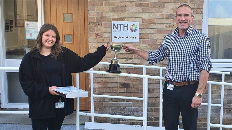 Apprentice Olivia Hawke is given a trophy by NTH Solutions managing director Mike Worden.