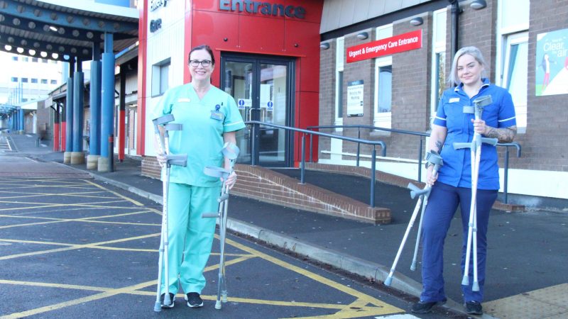 Staff stand outside the urgent and emergency care centre at North Tees. They are holding crutches.
