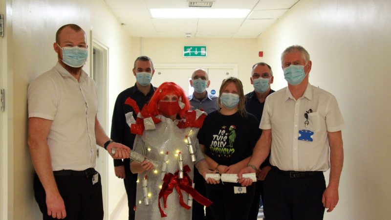 Carol with the medical engineering team. Carol is dressed as a silver Christmas cracker.