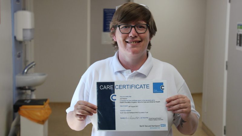 Jodie Pearson holding her care certificate.