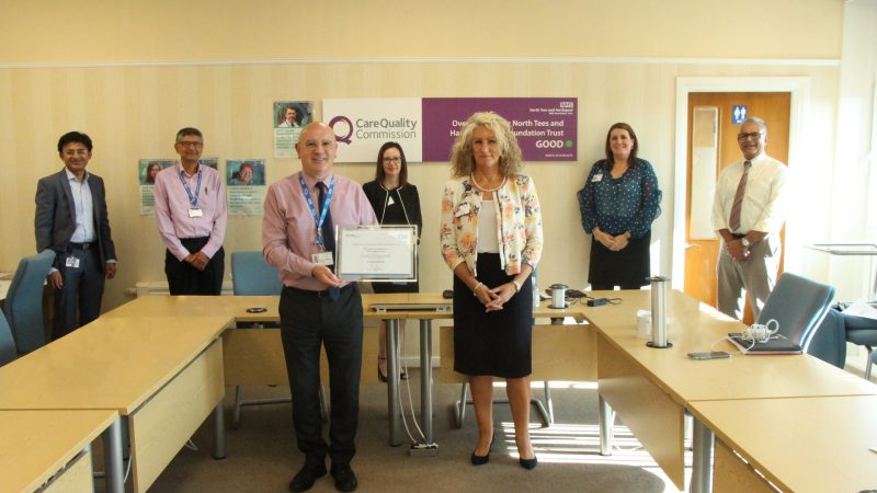 Graham Evans, chief executive Julie Gillon and members of staff from the Trust. Graham holds a certificate.