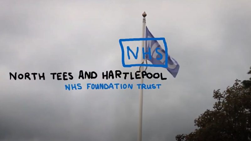 An NHS flag on a flag pole. Text written over the top reads: "North Tees and Hartlepool NHS Foundation Trust".
