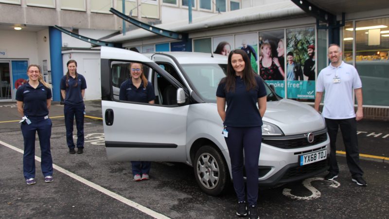 Staff stand in front of a car outside the University Hospital of North Tees.