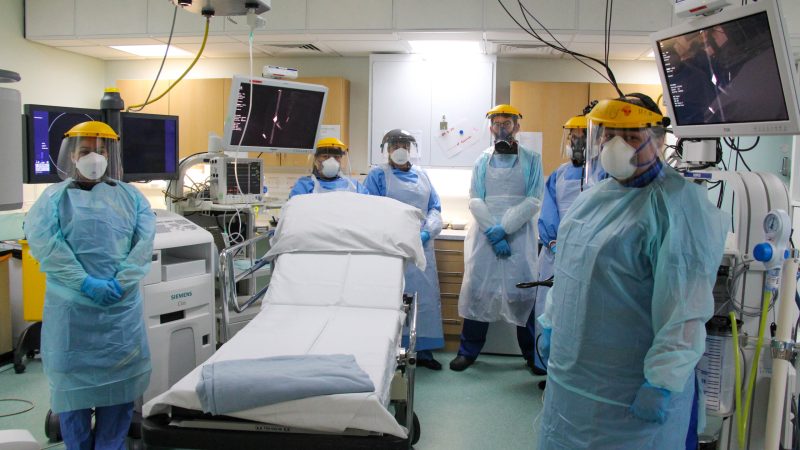 The endoscopy team in an operating theatre. They wear full PPE.